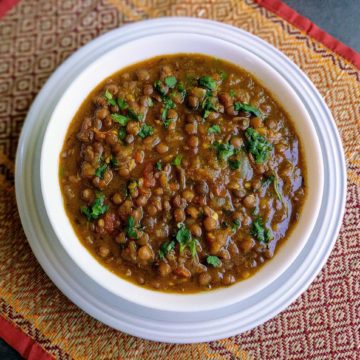 Sabut Masoor Dal is a delicious & wholesome Indian stew made from whole brown lentils cooked in a Punjabi onion tomato gravy. It is a healthy dish that goes really well with Rice or Rotis.