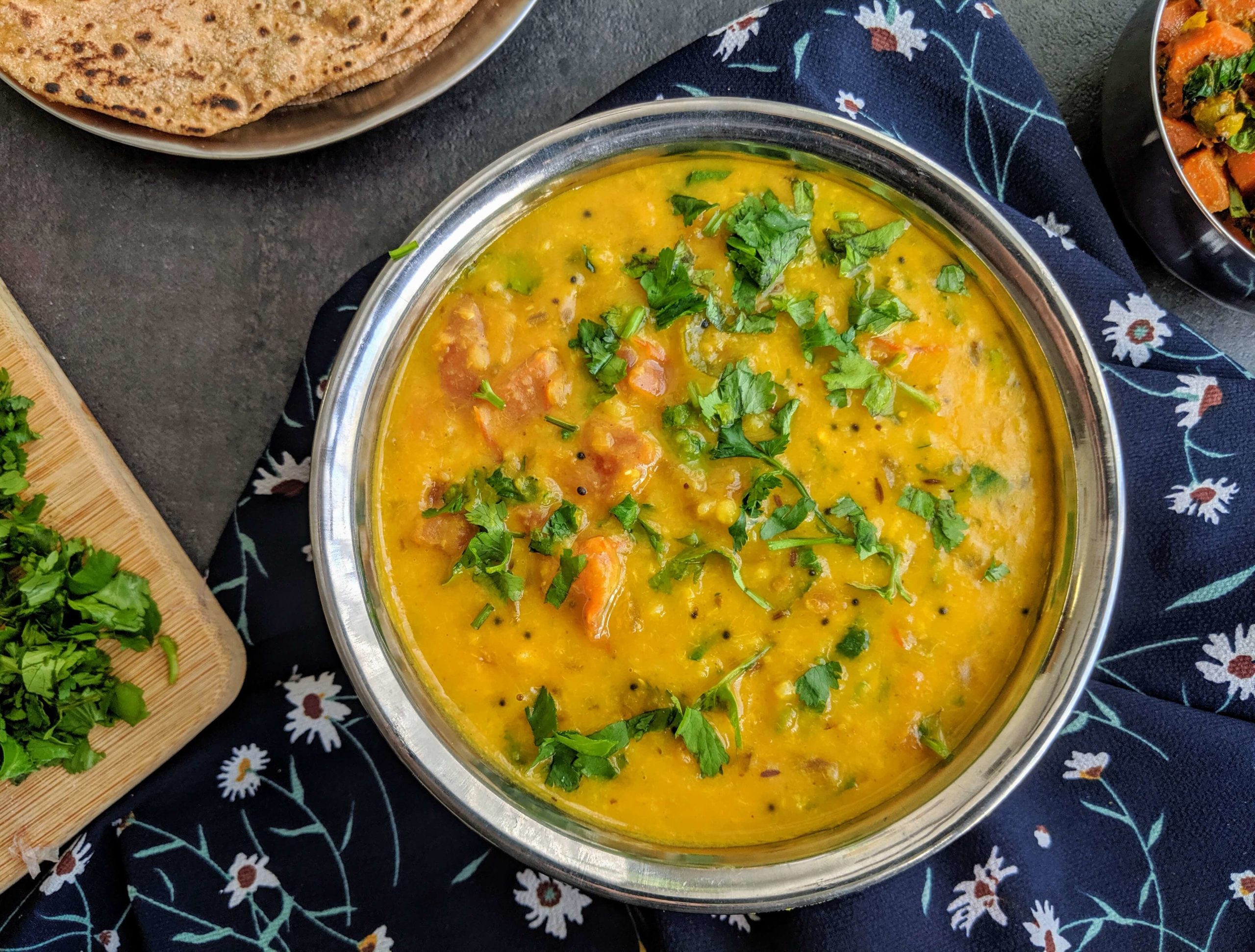 Moong Dal Tadka is a simple Indian dish made from yellow moong lentils cooked with a tempering made of onion, tomato and spices.