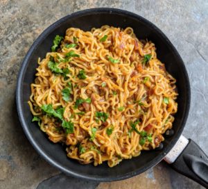 Street style maggi noodles are a spicy snack made by tossing maggi noodles in an onion tomato masala along with some spices.
