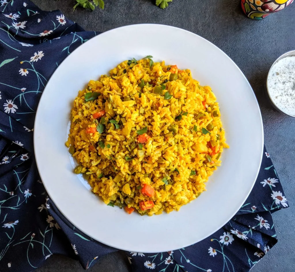 Tawa pulao is a spicy and popular street food from Mumbai, made with rice cooked with vegetables and flavored with pav bhaji masala.