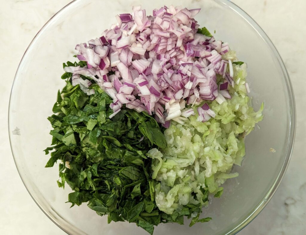 Green Moong Dal Chilla Recipe Step 4 - spinach, onion, grated lauki