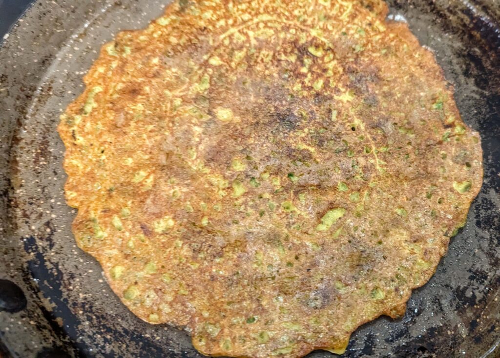 Green Moong Dal Chilla Recipe Step 8 - cook the chilla