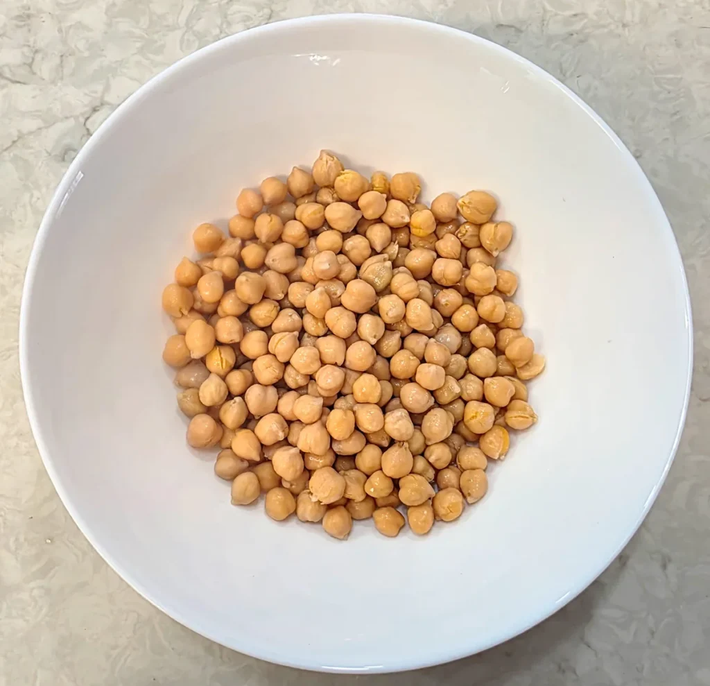 Boiled white chickpeas in a white ceramic bowl