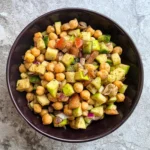 Apple chickpea kachumber salad served in a dark bowl